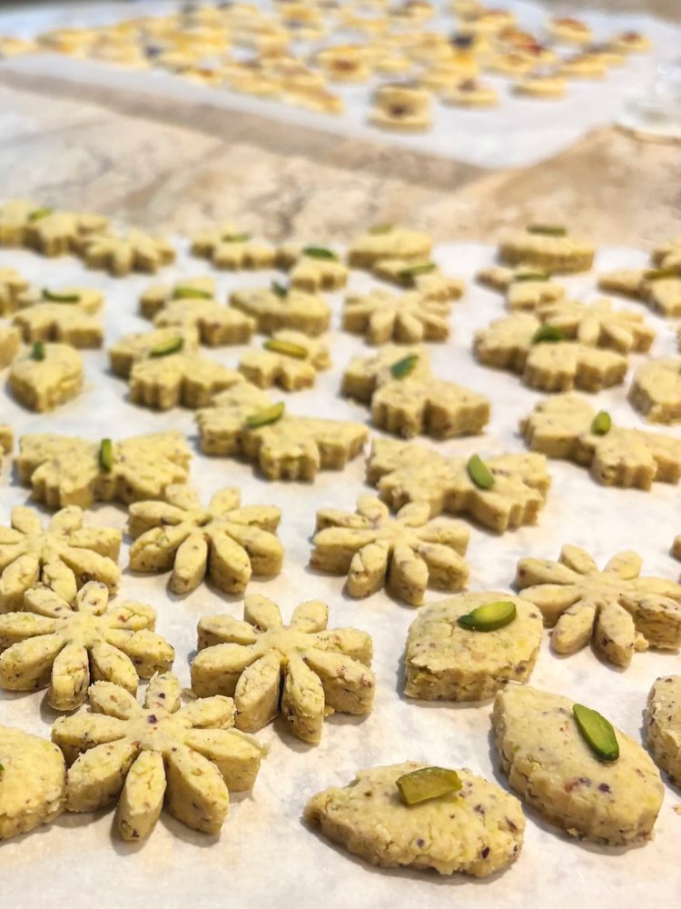 Flower shaped chickpea cookies topped with pistachio