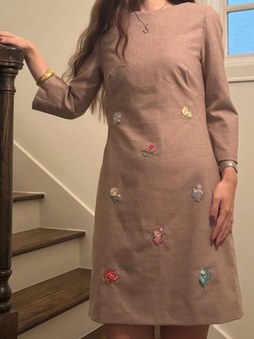 A dusty rose shift dress scattered with embroidered flowers